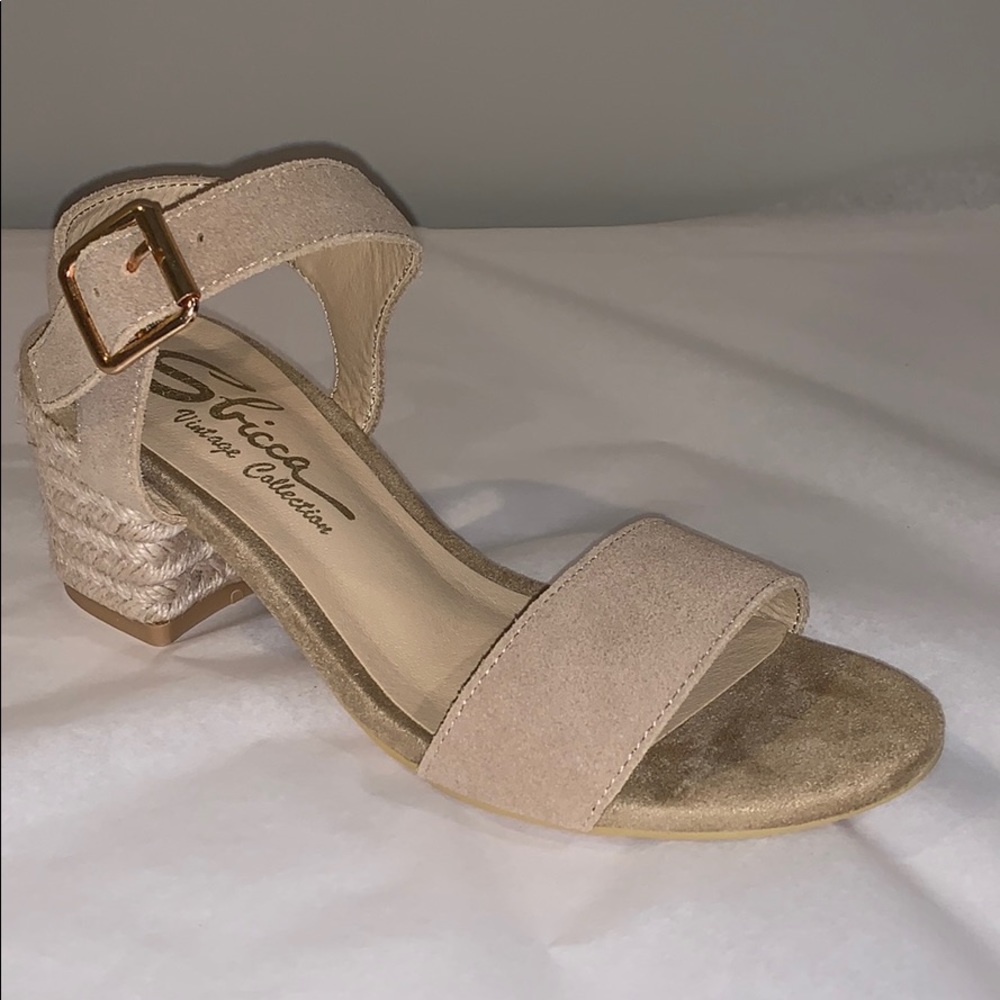 Cream strapped sandals with woven jute heel.